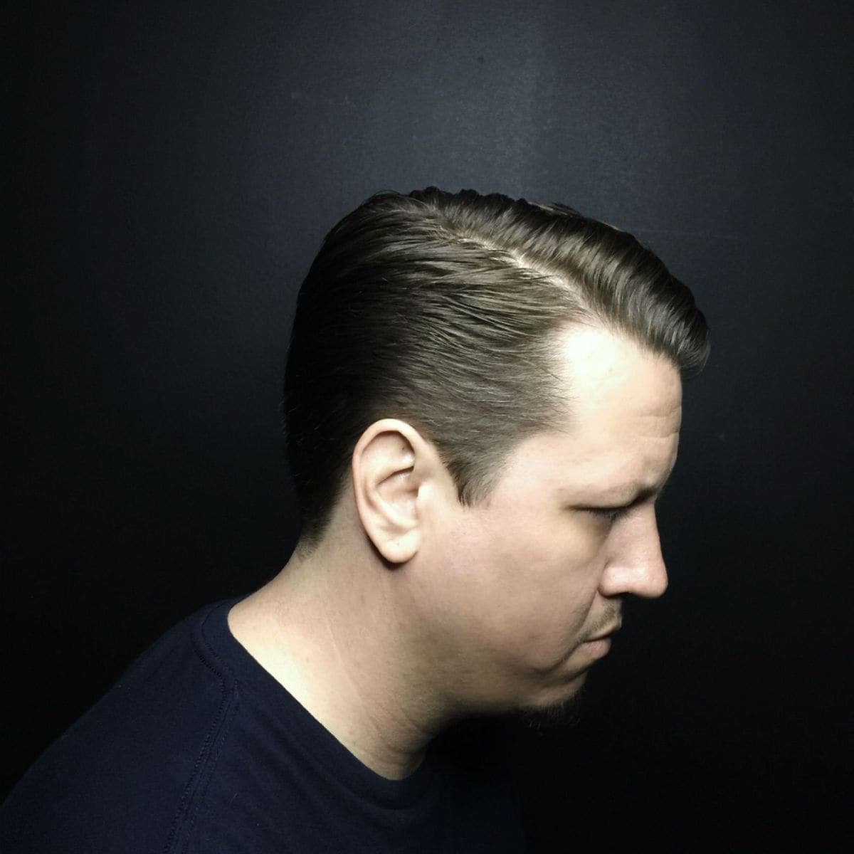 Classic side part with slick finish