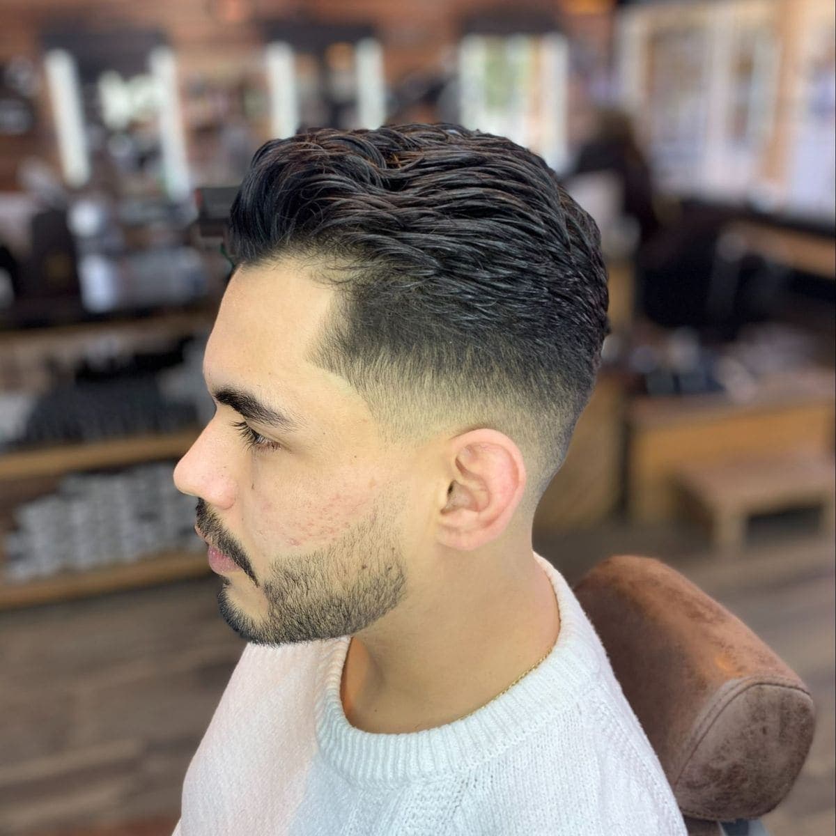 Low fade with wavy textured top and beard