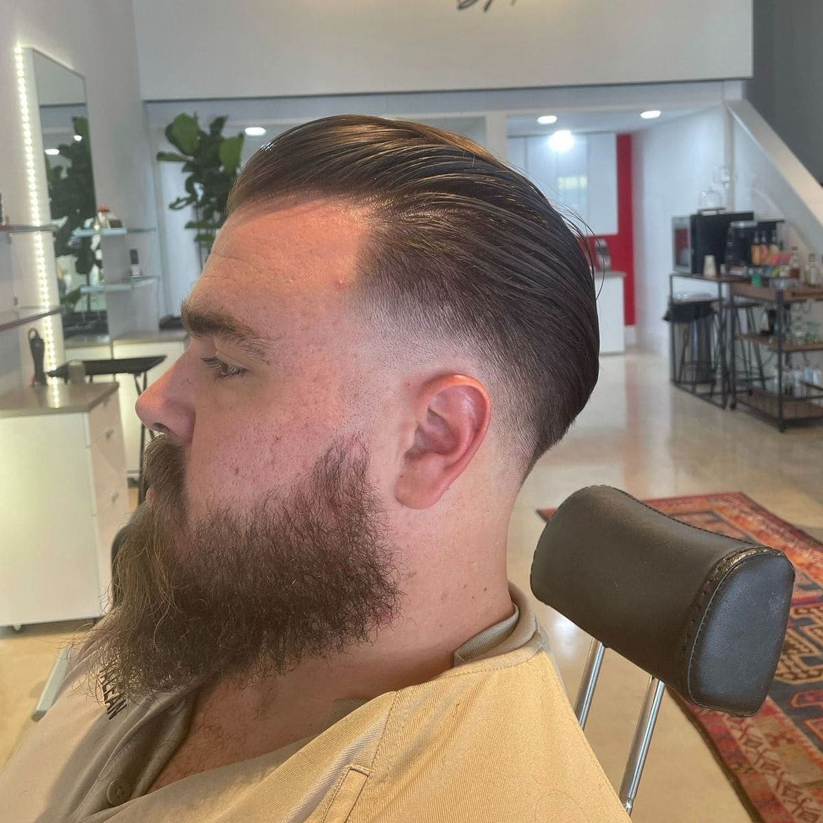 Slicked back undercut with full beard