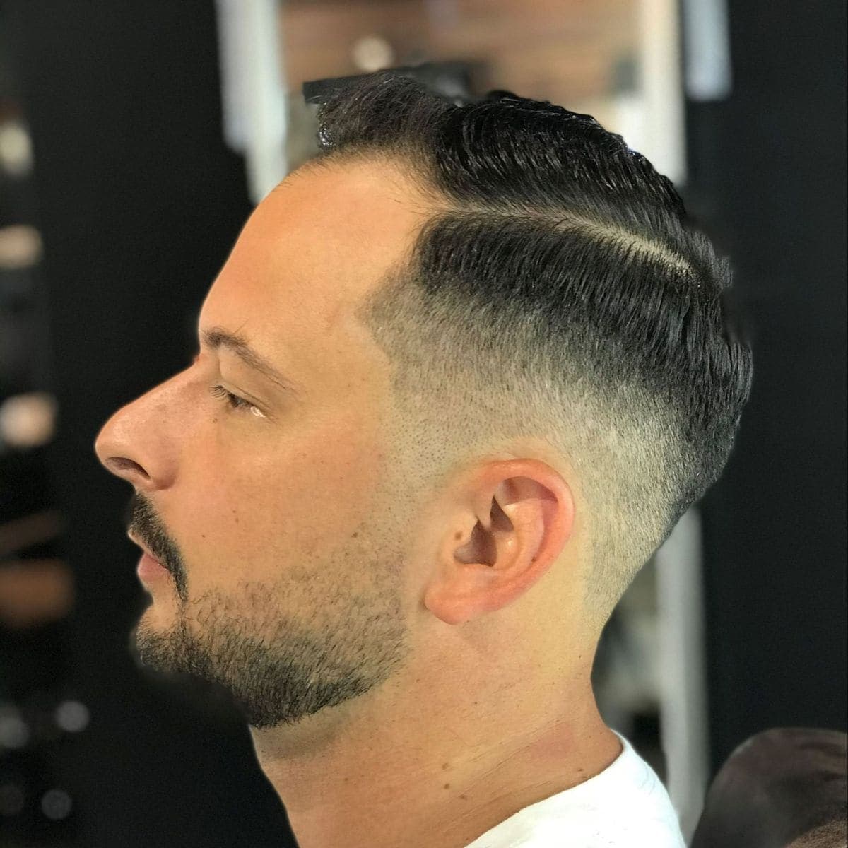 Sharp high fade with hard part