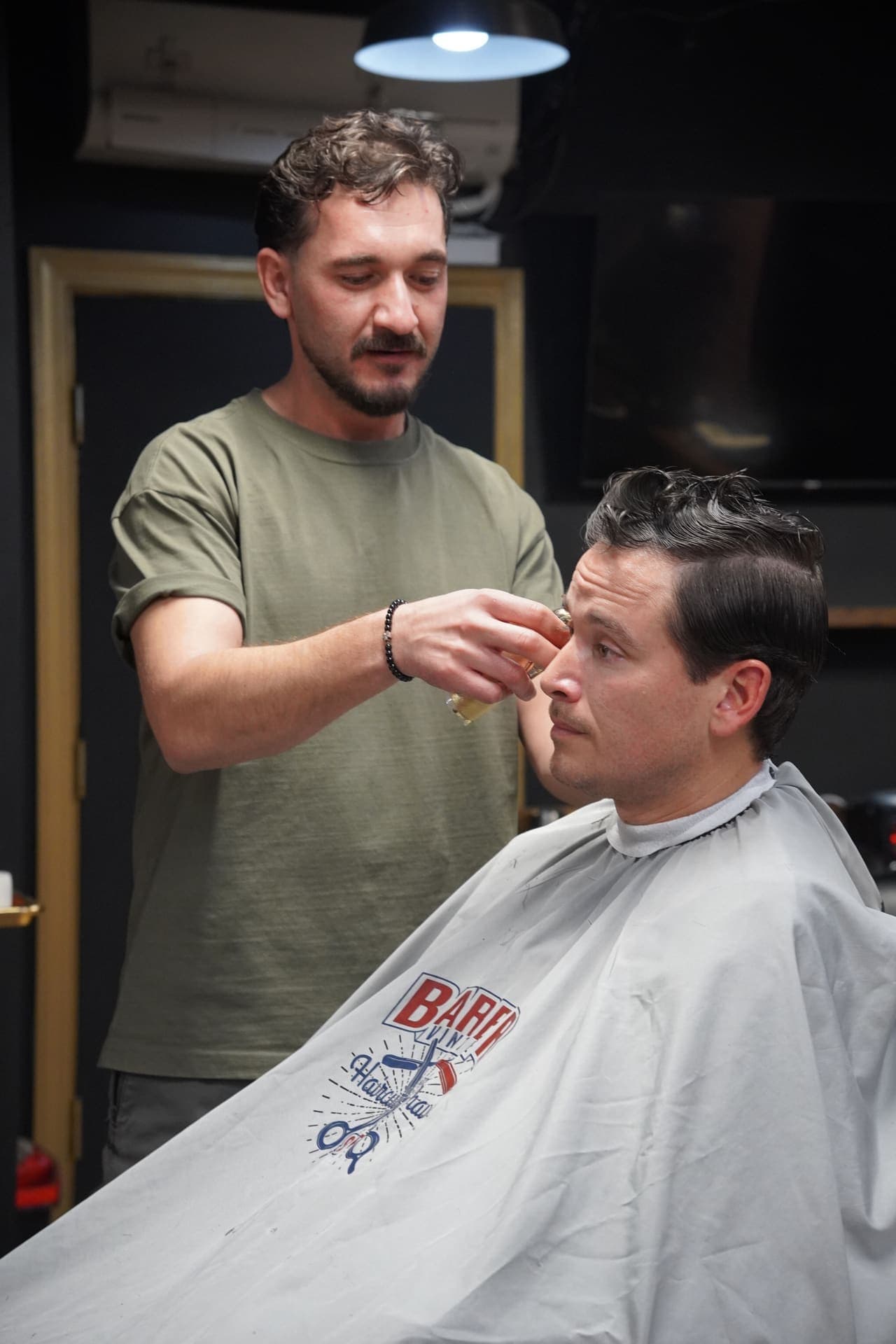 Barber shaping a client's hairline