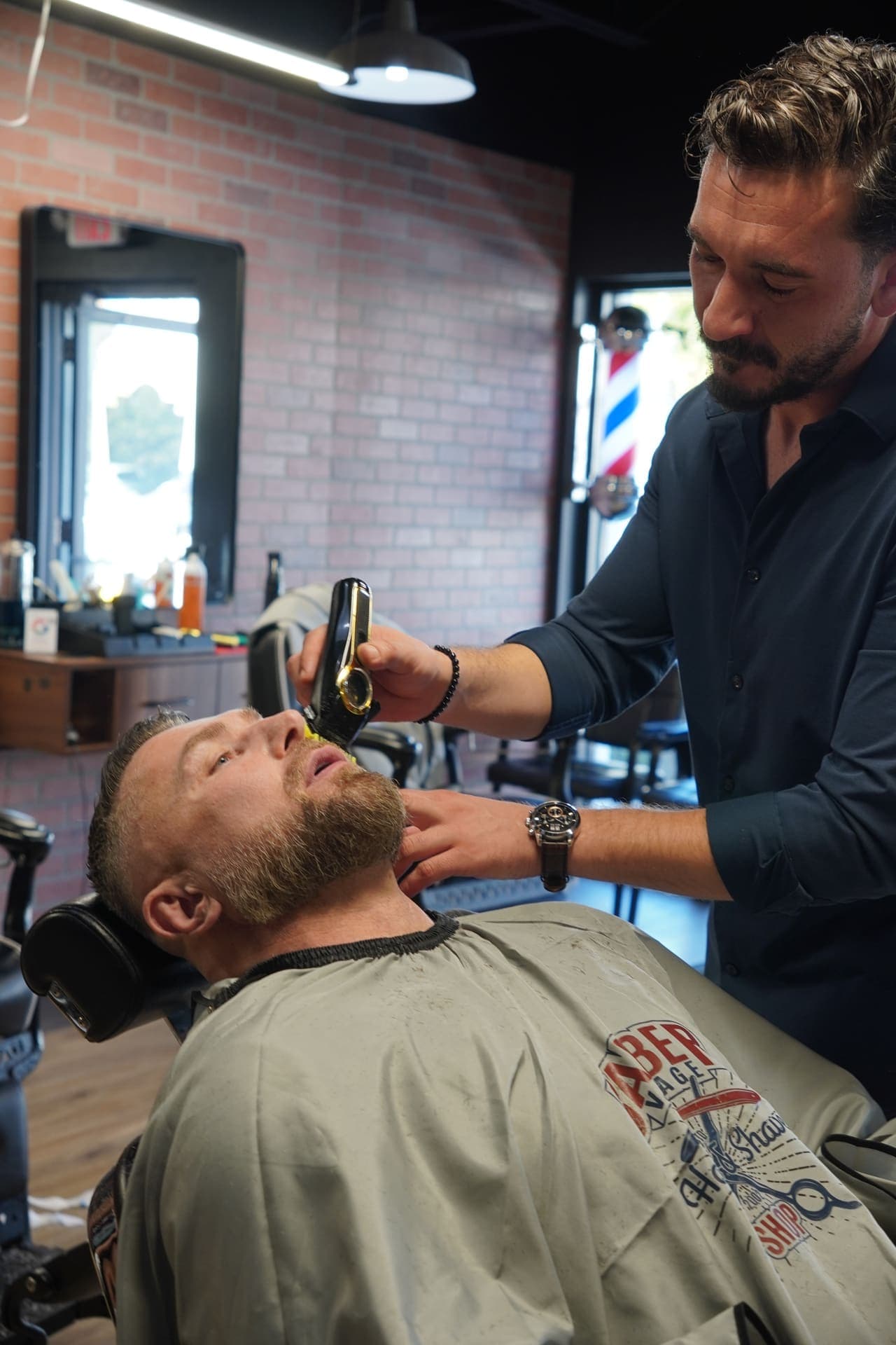 Master barber trimming a client's beard
